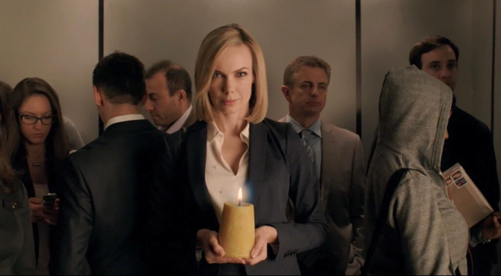 Amanda Walsh as an unnamed lawyer with candle - Lost Girl 502