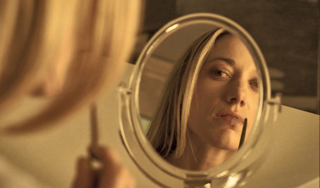 Lauren (Zoie Palmer) removes the DNA sample of The Morrigan she collected with a kiss. - Lost Girl 406