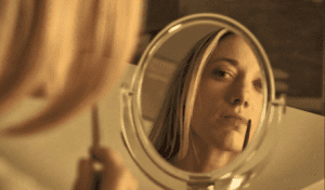 Lauren (Zoie Palmer) removes the DNA sample of The Morrigan she collected with a kiss. - Lost Girl 406