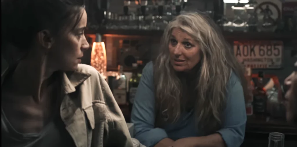 Suliane Brahim as Police Chief Weiss (left) in conversation with bar proprietor Sabine (Brigitte Sy) - Black Spot