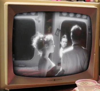 Chloe Rose as Fifi and Justin Chatwin as Bobby on black and white TV - Bang Bang Baby