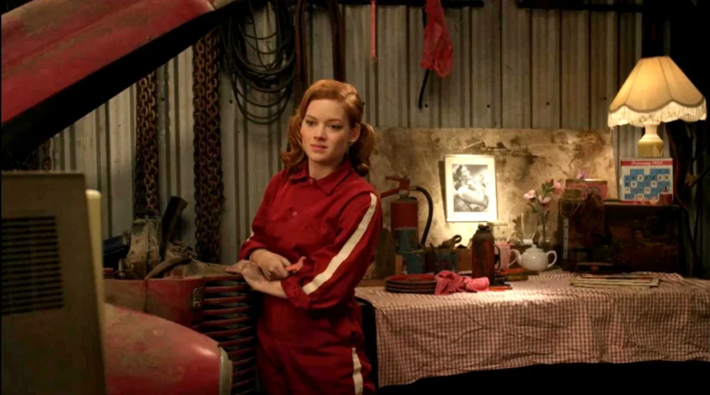 Jane Levy as Stepphy watching TV in her room. That's likely a photo of her mother, who left shortly after she was born, on the wall behind her. - Bang Bang Baby