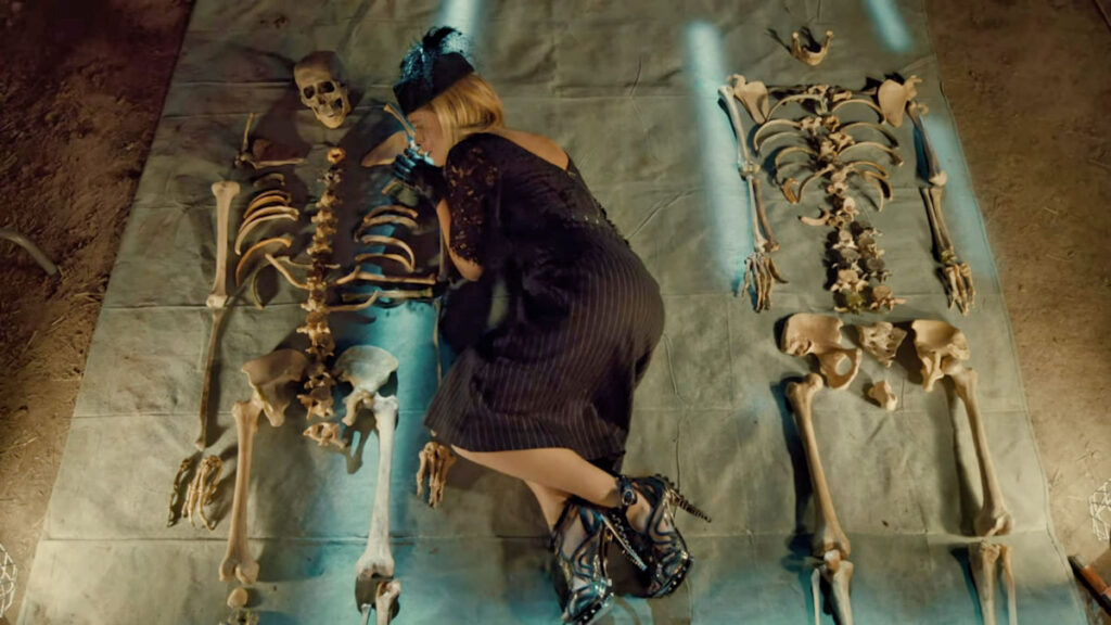 Rayisa Kondracki as Constance Clootie lying between two skeletons - Wynonna Earp - 105