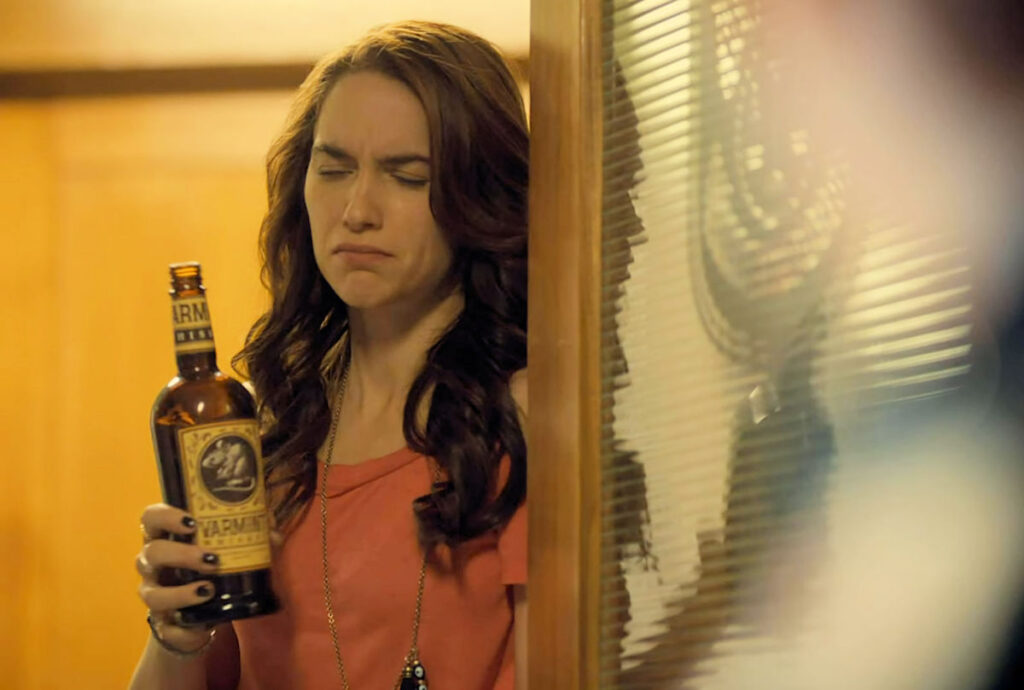 Melanie Scrofano as Wynonna with bottle of Varmint Whiskey - Wynonna Earp 107