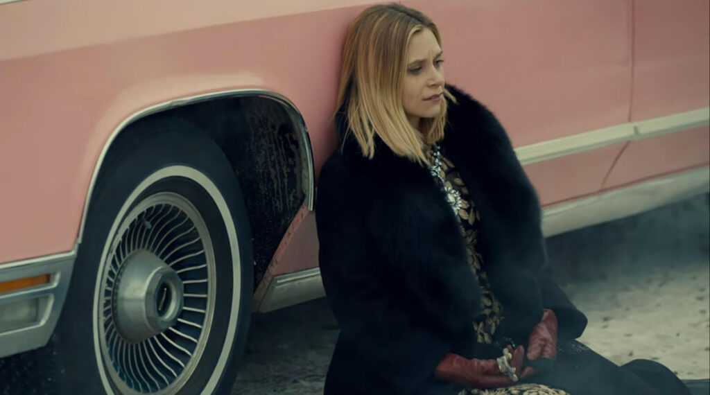 Rayisa Kondracki as Constance Clootie leaning against her pink Lincoln - Wynonna Earp 109