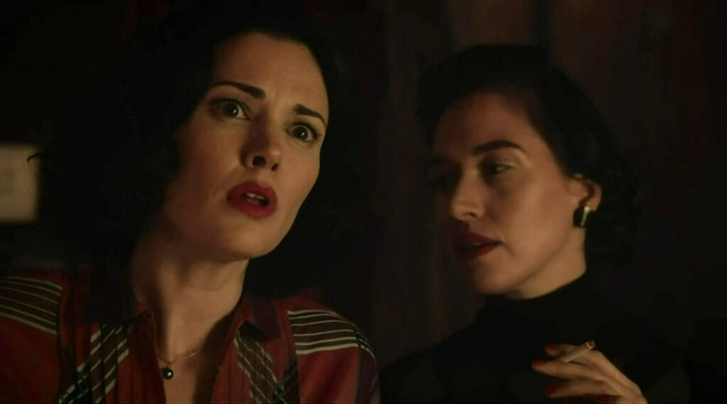 An unidentified woman whispers in the ear of Mimi (Laura Mennell) - Project Blue Book 102
