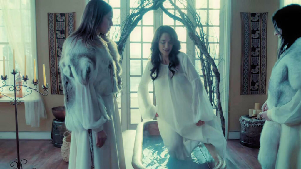 Eve (Natalie Krill) watches as Wynonna (Melanie Scrofano) is initiated into the cult with a ritual bath - Wynonna Earp 110