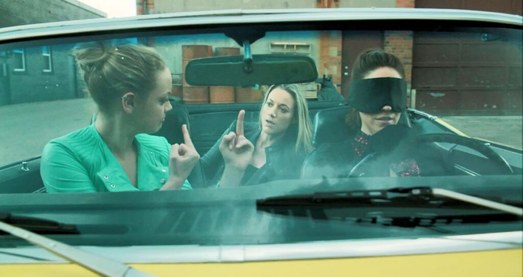 A blindfolded Bo goes for a drive. - Rachel Skarsten as Tamsin, Anna Silk as Bo, and Zoie Palmer as Lauren - Lost Girl 505