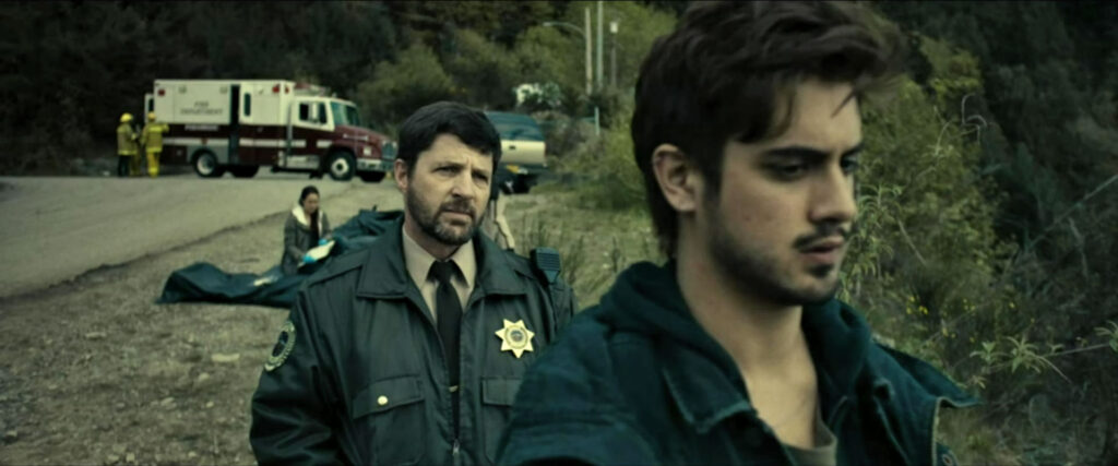 Sheriff Sam Perkins (Tim Guinee) and Roman Mercer (Avan Jogia) after the bus crash - Ghost Wars