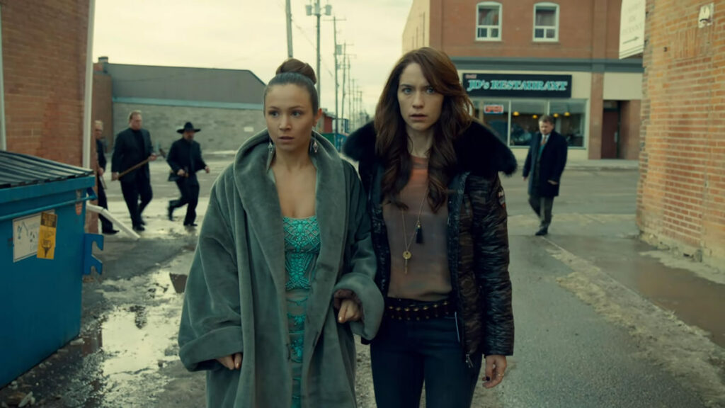 Waverly (Dominique Provost-Chalkley) and Wynonna (Melanie Scrofano) find themselves surrounded by an angry mob - Wynonna Earp 113