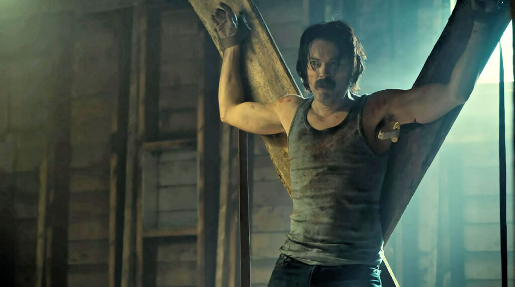 Tim Rozon as Doc Holliday tied to something cross-like in Bubba's laboratory - Wynonna Earp 112