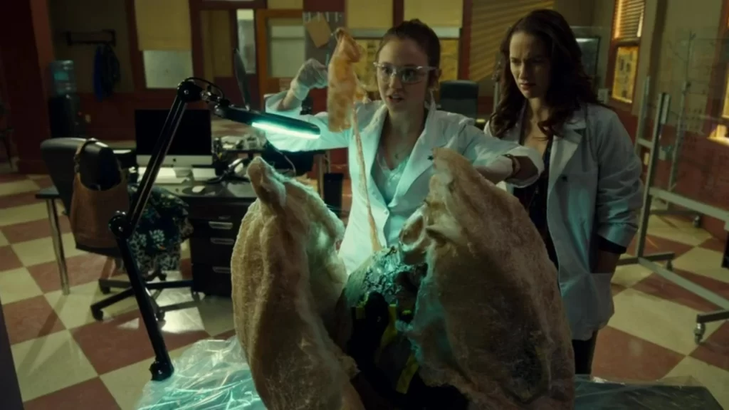 Dominique Provost-Chalkley as Waverly dissecting a large cocccoon - Wynonna Earp 202