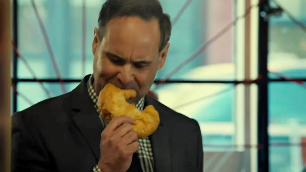 A Black Badge courier (Curt McKinstry) devours a croissant. - Wynonna Earp 204