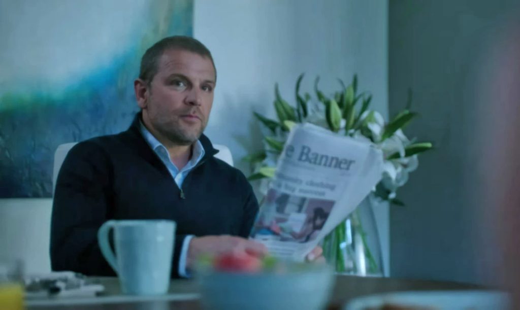David Cubitt as Ted Pownall with newspaper - Siren 103