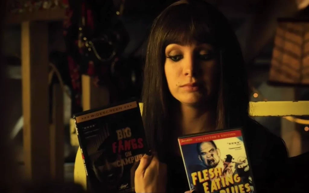 Kenzi (Ksenia Solo) tries to decide between zombie flicks. - Lost Girl 411