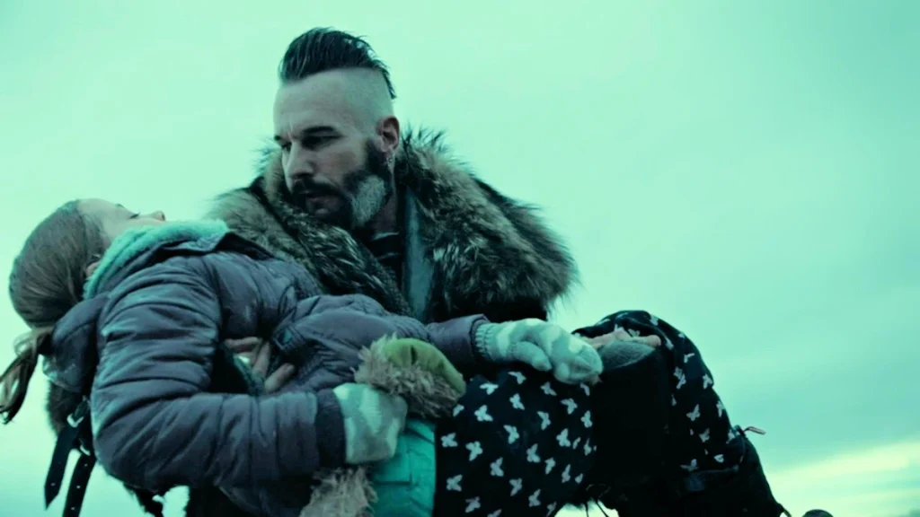 Bobo Del Rey (Michael Eklund) carries young Waverly (Summer McBrien) after rescuing her from the icy lake - Wynonna Earp 208
