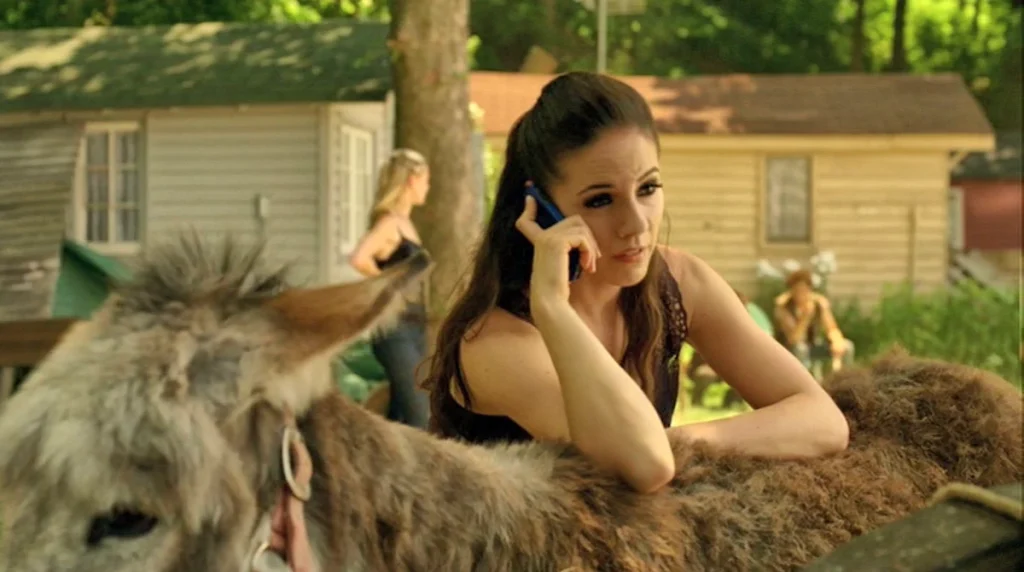 Bo (Anna Silk) phones Lauren while leaning on a donkey - Lost Girl 308