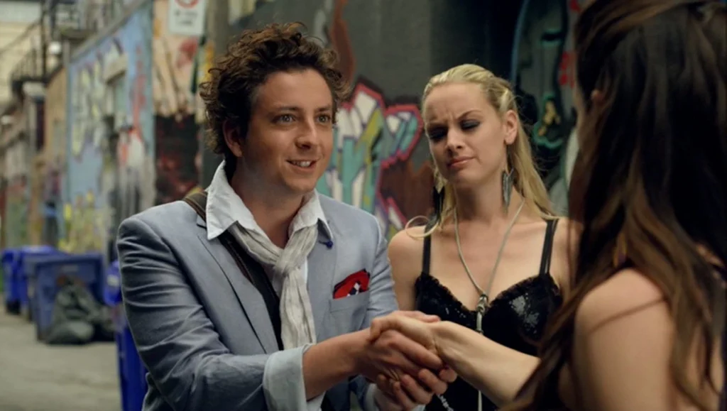 Balzac (Ryan Belleville) shakes hands with Bo, with Tamsin (Rachel Skarsten) looking on - Lost Girl 380